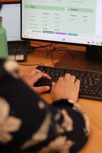 A.M.I. CPA Professional Corporation employee sitting at her desk, working on corporate bookkeeping