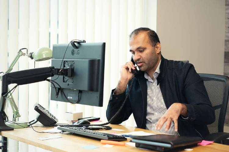 As a Senior Advisor at AMI CPA Professional Corporation in Oakville, Ahmad Amaduddin consults with a client on the phone about the steps required for developing a business plan.