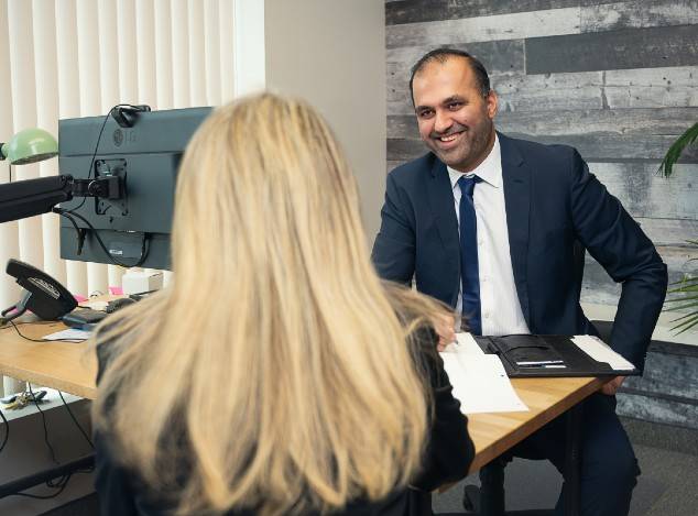 Ahmad, Senior CFO at AMI CPA Professional Corporation discusses options with a Burlington-based business for outsourcing their bookkeeping.