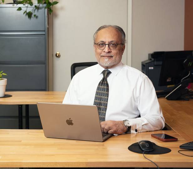 Chief Operating Officer at A.M.I., Mumtaz A. Butt, in his Oakville office in from of his computer.